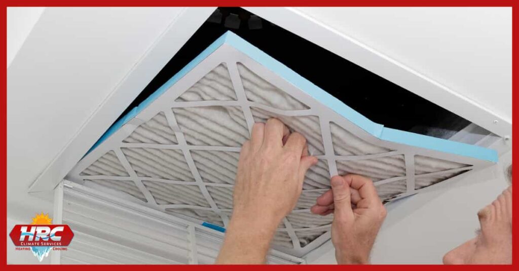 person changing air filter